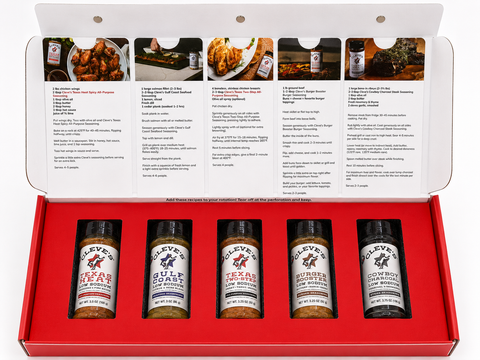Cleve’s Gourmet Products Texas seasoning gift box with five low sodium seasoning bottles, recipe cards, and branded red packaging featuring Texas Heat, Gulf Coast, Texas Two-Step, Burger Booster, and Cowboy Charcoal.
